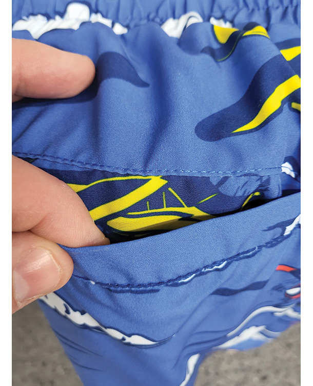 blue aviation themed swimming trunks pocket close up